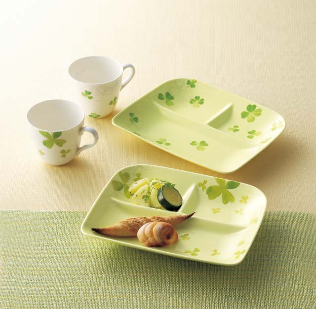 The lunch plates are light green with clover patterns and the mug cups are