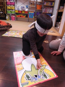 A Child Playing a Pokemon Fukuwarai. "yamakazz" some rights reserved. flickr